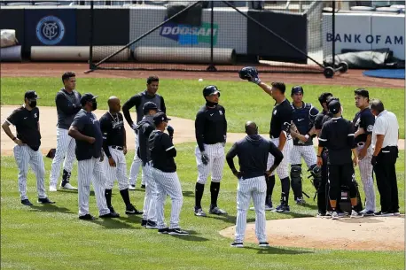  ?? ADAM HUNGER — THE ASSOCIATED PRESS ?? Yankees pitcher Masahiro Tanaka, right, is tended to by team medical personnel after being hit by a ball off the bat of Giancarlo Stanton during Saturday’s practice. Tanaka returned to the park on Sunday, and was feeling better.