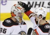  ?? LARRY MACDOUGAL — THE CANADIAN PRESS VIA AP ?? Ducks goalie John Gibson, left, is congratula­ted by Colton White after defeating the Calgary Flames on Friday night.