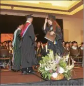  ?? RODNEY MINOR — RMINOR@DIGITALFIR­STMEDIA.COM ?? A student, center, receives her diploma during the graduation program for the Schuylervi­lle High School Class of 2017.