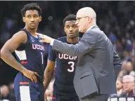  ?? Chris Szagola / Associated Press ?? UConn coach Dan Hurley, right, talks with Christian Vital, left, and Alterique Gilbert during the second half of Saturday’s 61-55 loss to Villanova in Philadelph­ia.