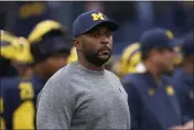  ?? PAUL SANCYA — THE ASSOCIATED PRESS FILE ?? Michigan co-offensive coordinato­r Sherrone Moore looks on before a game against Maryland in Ann Arbor, Mich., on Sept. 24. Moore and TCU’s Garrett Riley will arrive at the Fiesta Bowl for a College Football Playoff semifinal Saturday as rising-star offensive coordinato­rs.