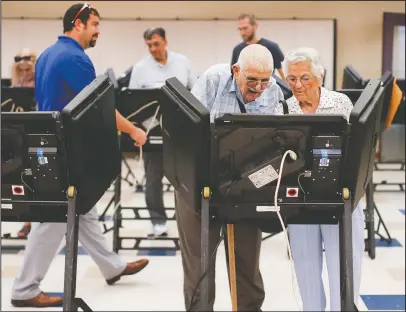  ?? The Associated Press ?? POLLING STATION: Voters cast their ballots among an array of electronic voting machines in a polling station at the Noor Islamic Cultural Center, Tuesday in Dublin, Ohio. Two-term state Sen. Troy Balderson, is fighting off a strong challenge from Democrat Danny O’Connor, a 31-year-old county official, in a congressio­nal district held by the Republican Party for more than three decades.