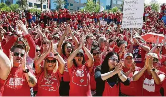  ?? Ross D. Franklin / Associated Press ?? Teachers converge on the Arizona Capitol on Thursday in Phoenix. After an all night budget session, legislator­s passed raises for teachers, with Gov. Doug Ducey signing the measure.