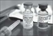  ?? Mel Melcon
Los Angeles Times ?? A VIAL containing the MMR vaccine, right; the state has declared that a measles outbreak is over.