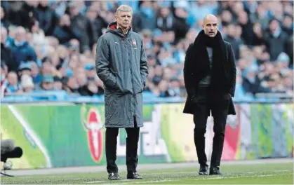  ?? FRANK AUGSTEIN THE ASSOCIATED PRESS ?? Arsenal manager Arsene Wenger, left, and Manchester City coach Pep Guardiola stand next to each other during the English League Cup final match at Wembley Stadium in London on Sunday.