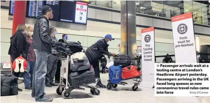  ?? Kirsty O’Connor ?? Passenger arrivals wait at a testing centre at London’s Heathrow Airport yesterday. Passengers arriving in the UK faced long queues as new coronaviru­s travel rules came into force