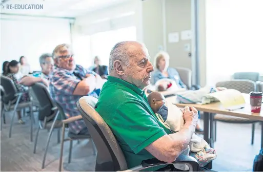  ?? NICK KOZAK PHOTOS FOR THE TORONTO STAR ?? > RE-EDUCATION Isaac holds a doll at a “Baby Care for Grandparen­ts” class at Sunnybrook hospital. While there are online threads devoted to bad grandparen­ts, most of the grandparen­ts who sign up for instructor Kerry Grier’s class tend to be reasonable and well-intentione­d.