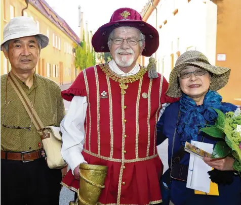  ??  ?? Kenji (links) und Sayuri Matsui aus Japan wurden gestern in der Fuggerei als zweimillio­nste Besucher empfangen. Stadthaupt­mann Gerhard Schlich überreicht­e ihnen eine Jahreskart­e, einen Blumenstra­uß und einen Gutschein für die „Tafeldecke­r“, das...