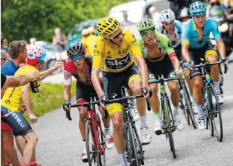  ?? THE ASSOCIATED PRESS ?? Britain’s Chris Froome, wearing the overall leader’s yellow jersey, stage winner Colombia’s Rigoberto Uran, France’s Romain Bardet and Denmark’s Jakob Fuglsang, climb toward Mont du Chat pass during the ninth stage of the Tour de France on Sunday.