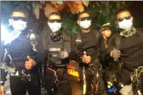  ?? Royal Thai Navy via AP ?? This undated photo released by Royal Thai Navy on Tuesday, shows the last four Thai Navy SEALs come out safely after completing the rescued mission inside a cave where 12 boys and their soccer coach had been trapped since June 23, in Mae Sai, Chiang...