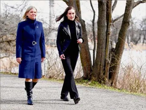  ?? Paul Wennerholm / AFP ?? Swedish Prime Minister Magdalena Andersson, left, and Finnish Prime Minister Sanna Marin walk prior to a meeting on whether to seek NATO membership, in Stockholm, Sweden, on April 13.