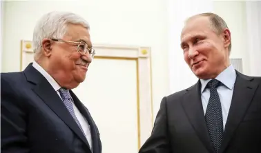  ??  ?? Russian President Vladimir Putin, right, shakes hands with Palestinia­n leader Mahmoud Abbas during their meeting at the Kremlin in Moscow on Monday. (AFP)