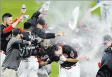  ?? David Richard ?? USA Today Jay Bruce, center, ducking, celebrates with his Indians teammates Thursday after hitting a walk-off RBI double in the 10th inning of Cleveland’s victory over the Royals, the Tribe’s Al-record 22nd straight win.