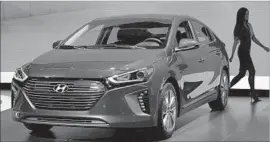  ?? Bryan Thomas Getty Images ?? THE HYBRID VERSION of the Hyundai Ioniq is shown at the New York auto show in March. The line will include a hybrid, an electric and a plug-in hybrid.