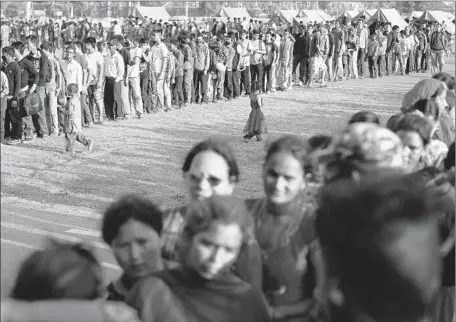  ?? Mast Irham
European Pressphoto Agency ?? SURVIVORS of Tuesday’s 7.3 aftershock line up for food in Katmandu, Nepal’s capital. The quake killed 91 in Nepal and 17 in India.