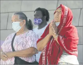  ?? NHAT V. MEYER — STAFF PHOTOGRAPH­ER ?? Vendors from the San Jose Flea Market and their supporters, including Francisca Mendoza, right, participat­e in a vigil for the future of the flea market at San Jose City Hall on Tuesday.