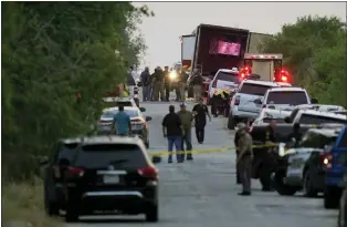  ?? ERIC GAY — THE ASSOCIATED PRESS ?? Authoritie­s work the scene where dozens of people were found dead and multiple others were taken to hospitals with heat-related illnesses after a semitraile­r containing suspected migrants was found Monday in San Antonio.