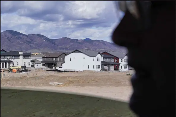  ?? REBECCA SLEZAK — SPECIAL TO THE DENVER POST ?? Harold Smethills, chairman of Sterling Ranch Developmen­t Company, rides in a car past homes in Sterling Ranch in Littleton on April 25.