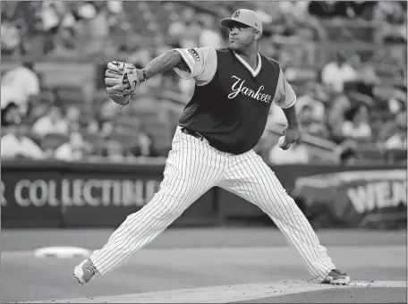  ?? FRANK FRANKLIN II/AP PHOTO ?? New York’s C.C. Sabathia winds up Friday, replete in the Yankees’ flashy uniform against Seattle.