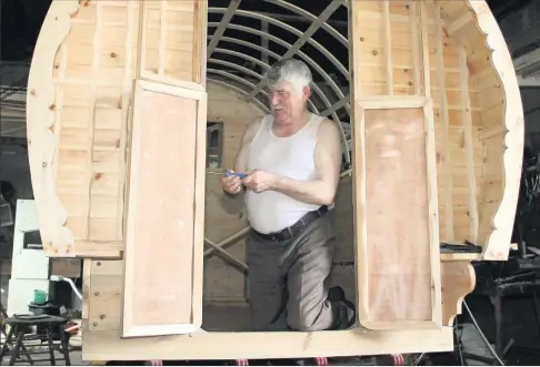  ??  ?? Willie Connors fitting the doors to the Barrell Top Wagon.