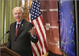  ?? (Arkansas DemocratGa­zette/ Staton Breidentha­l) ?? Gov. Asa Hutchinson points to a digital informatio­n chart during his daily COVID-19 briefing Friday at the state Capitol in Little Rock.