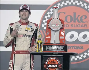  ?? PHOTOS BY PHELAN M. EBENHACK — THE ASSOCIATED PRESS ?? Ryan Blaney stands by the trophy Saturday after winning the NASCAR Cup Series race at Daytona.