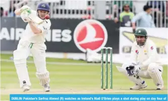  ??  ?? DUBLIN: Pakistan’s Sarfraz Ahmed (R) watches as Ireland’s Niall O’Brien plays a shot during play on day four of Ireland’s inaugural Test match against Pakistan at Malahide cricket club, in Dublin yesterday. —AFP