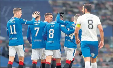  ??  ?? Ryan Jack is mobbed by teammates after scoring