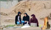  ?? AP/PTI ?? Palestinia­ns visit the graves of their relatives who were killed in the war between Israel and the Hamas militant group