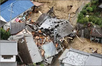  ?? ASSOCIATED PRESS ?? RESIDENTIA­L BUILDINGS ARE damaged by a landslide caused by heavy rains in Sakacho, Hiroshima prefecture, southweste­rn Japan, Saturday. Torrents of rainfall and flooding continued to batter southweste­rn Japan.