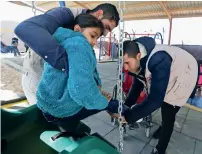  ?? Reuters ?? Staff members help a child at a new park designed for all children including people with various physical disabiliti­es in Al Zaatari refugee camp, in the Jordanian city of Mafraq, near the border with Syria. —