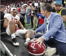 ?? John Bazemore The Associated Press ?? Alabama quarterbac­k Tua Tagovailoa is taken off the field after the SEC title game Saturday. Some wonder if the injury will affect his Heisman Trophy chances.