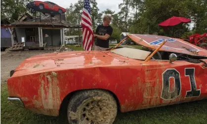  ?? ?? Actor John Schneider, who starred in the television show The Dukes of Hazzard, checks on one ofhis General Lee cars. Photograph: Chris Granger/AP