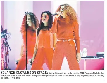  ??  ?? Solange Knowles (right) performs at the 2017 Panorama Music Festival on Randall’s Island in New York Friday. Solange and her eight-piece band had a touch of Prince as they played decked out in matching red outfits. — AFP photo