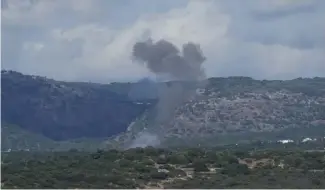  ?? ?? Smoke rises in northern Israel following a rocket strike from Lebanon.