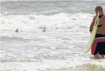  ?? ROGER SIMMS /AP ?? With a recorded 238 shark attacks, New Smyrna Beach has been named the “Shark Bite Capital of the World.” However, this name doesn’t keep visitors away from enjoying the sand and sun.