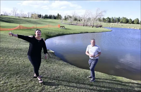  ?? CLIFF GRASSMICK/STAFF PHOTOGRAPH­ER ?? Crystal Chinn, left, and Kevin Grossi explain how they saved a young boy in late November after he slid into the icy pond in the background at Purple Park in Superior.