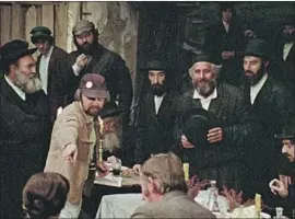  ?? NORMAN JEWISON Zeitgeist Films / Kino Lorber ?? (pointing) and Topol (holding hat) on the 1971 film’s set.