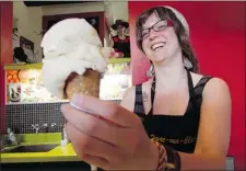  ??  ?? Jacinthe Leger-Leduc serves up a cone of ginger ice cream at Havre-auxGlaces in Jean Talon Market.