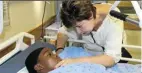  ?? Picture: Orrin Singh ?? S’bani Phiri, 11 at the time, gets some words of encouragem­ent from her teacher Debbie Lane after the collapsing wall broke her pelvis. Sixteen people died in the incident.