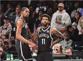  ?? Al Bello/TNS ?? The Brooklyn Nets’ Kevin Durant, left, and Kyrie Irving (11) look on in the final seconds of a 109-103 loss against the Boston Celtics during Game 3 of the Eastern Conference first-round playoff series at Barclays Center on April 23 in New York. Durant said that he can’t fault Irving for requesting a trade out of Brooklyn.