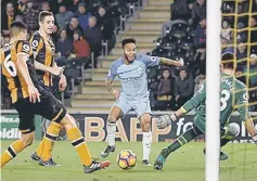  ??  ?? Hull City’s Curtis Davies (left) scores an own goal and the third goal for Manchester City. — Reuters photo