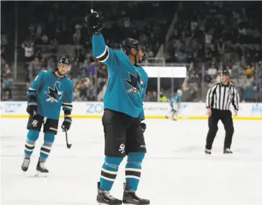  ?? Ben Margot / Associated Press ?? The Sharks’ Evander Kane celebrates one of his three firstperio­d goals against the Hurricanes.