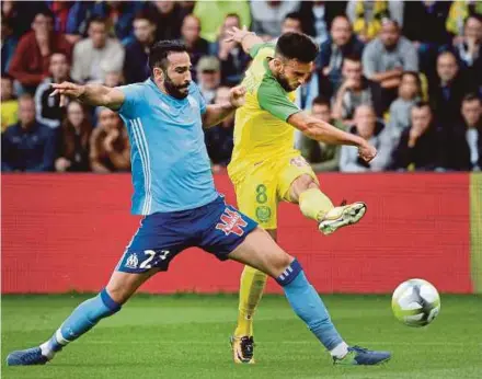  ?? AFP PIC ?? Nantes’ Adrien Thomasson (right) shoots under a challenge from Marseille’s Adil Rami in their Ligue 1 match at Beaujoire Stadium on Saturday.