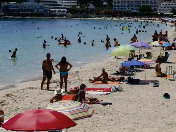  ??  ?? People on Magaluf beach in Mallorca yesterday (Reuters)