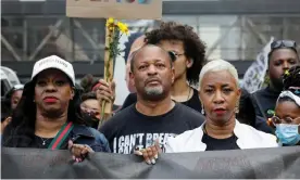  ?? Photograph: Nicholas Pfosi/Reuters ?? George Floyd's cousin Shareeduh Tate and aunt Angela Harrelson hold a banner as they march with others in Minneapoli­s in May.