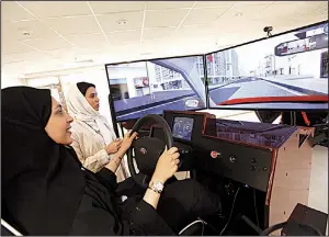  ?? Bloomberg News/MOHAMMED AL-NEMER ?? A woman tests her skills earlier this week in a simulator at a driving school in Dhahran, Saudi Arabia. The Saudi ban on female drivers ends Sunday.