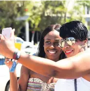  ?? NORMAN GRINDLEY/CHIEF PHOTO EDITOR ?? Winding down for carnival road march tomorrow, Afesha Chong (left) and Ghirma Henry from New York City, USA, take a selfie before boarding the Treasure Queen boat for a soca party in Kingston Harbour yesterday. The two are among scores of visitors to...