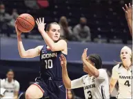  ?? Gary Landers / Associated Press ?? UConn guard Nika Muhl ( 10) looks to pass over Xavier guard Aaliyah Dunham ( 3) during the first half on Saturday.