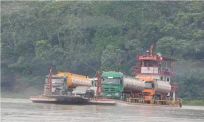  ?? Photograph: Thierry Mallet/Reuters ?? Oil tankers being ferried across Ecuador’s Napo River, a tributary of the Amazon.